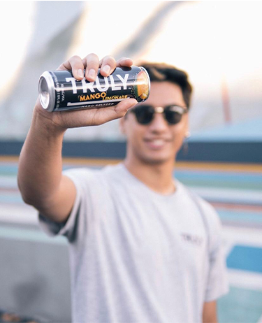 Man holding up a can of Truly